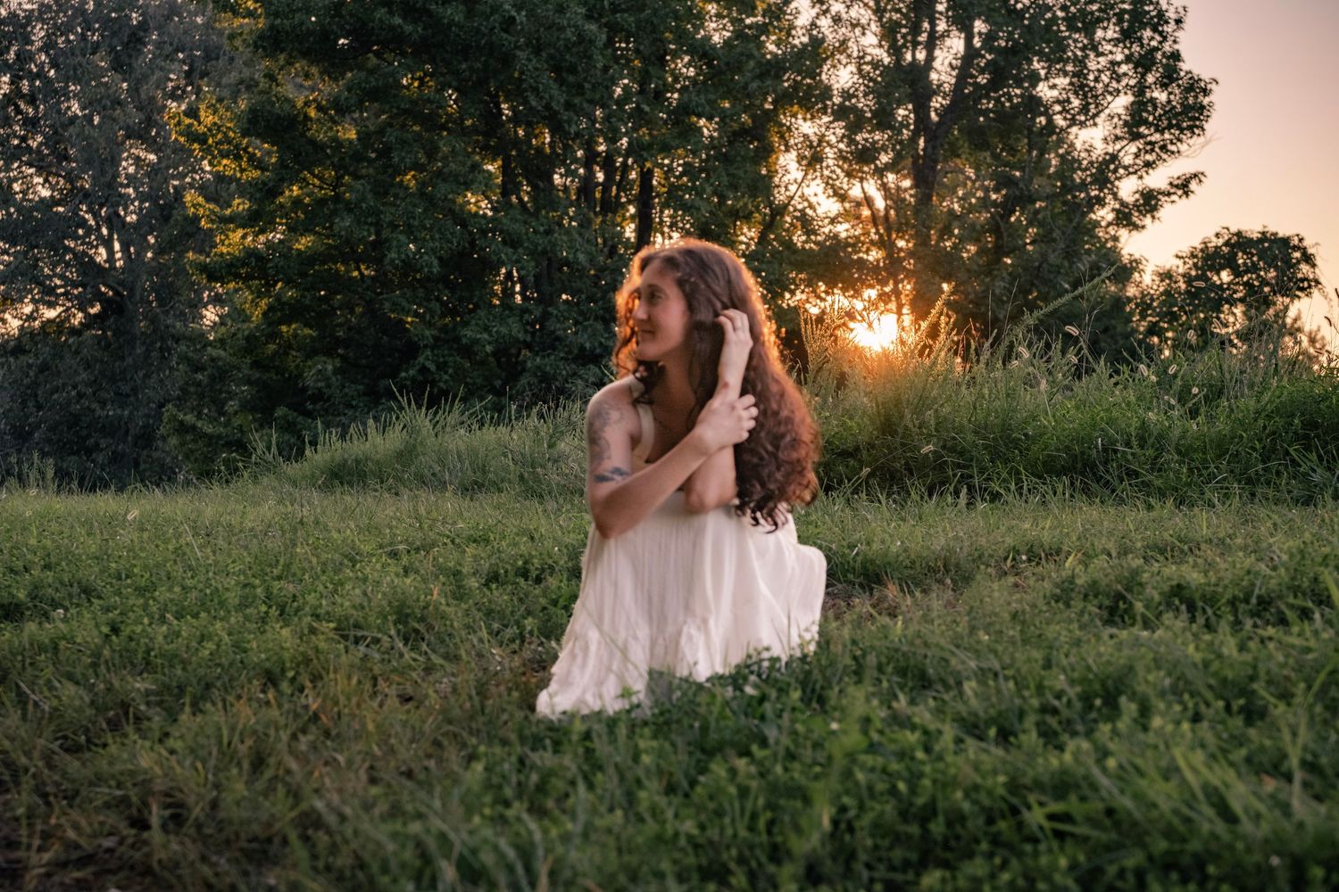 Romantic evening photoshoot in a field at golden hour.