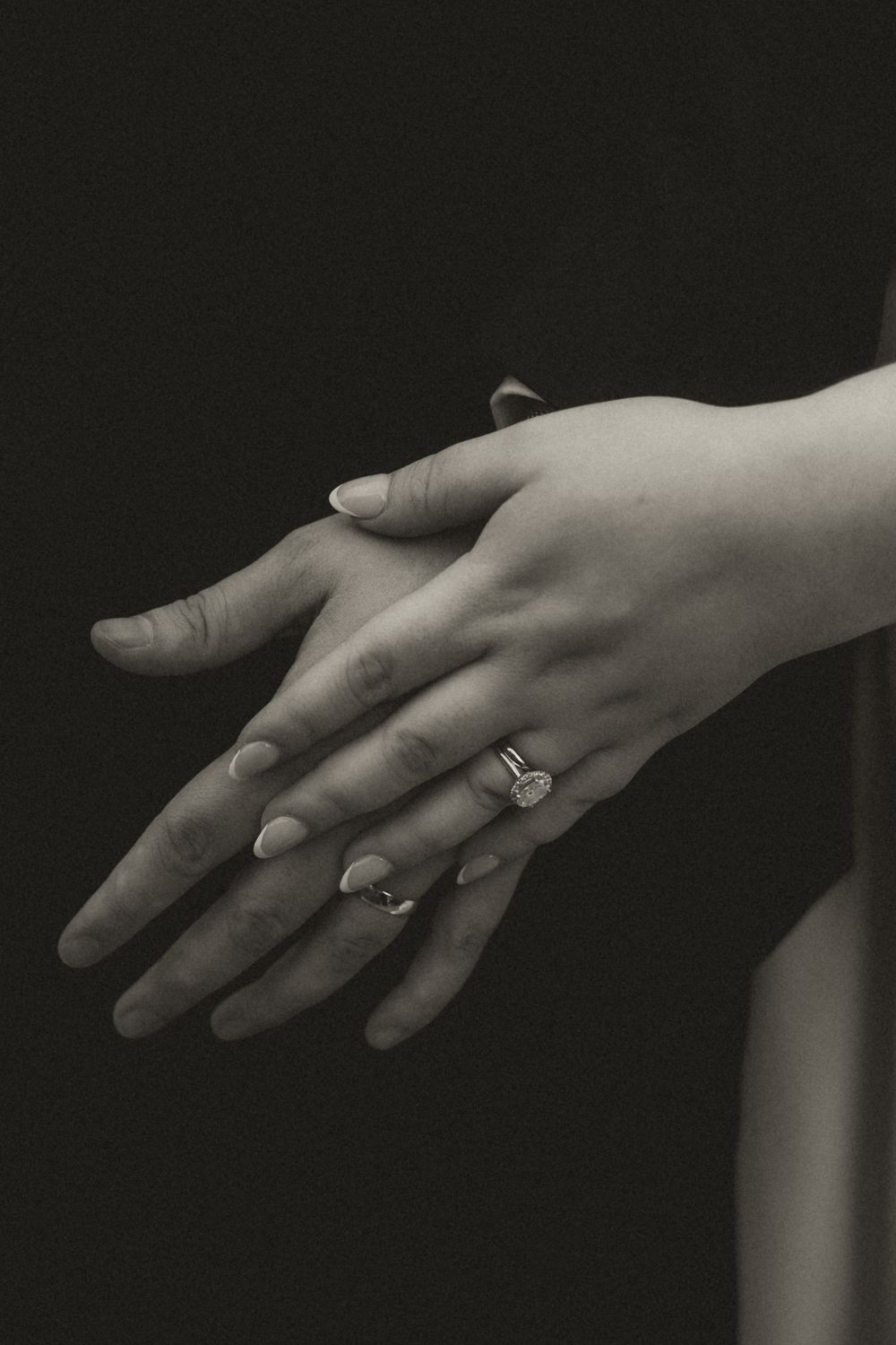 Black and white photo sequence showing a hand with an engagement ring from different angles and positions.