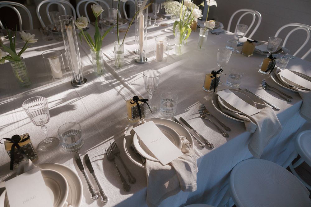 Time-lapse series of high-end restaurant table settings arranged in a row with sophisticated glassware and metallic accents.