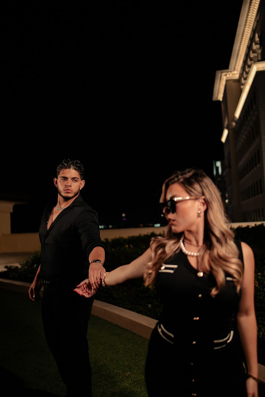 Editorial Miami night portrait of couple hand in hand, cinematic engagement photography perfect for Instagram by MannyPortraits.