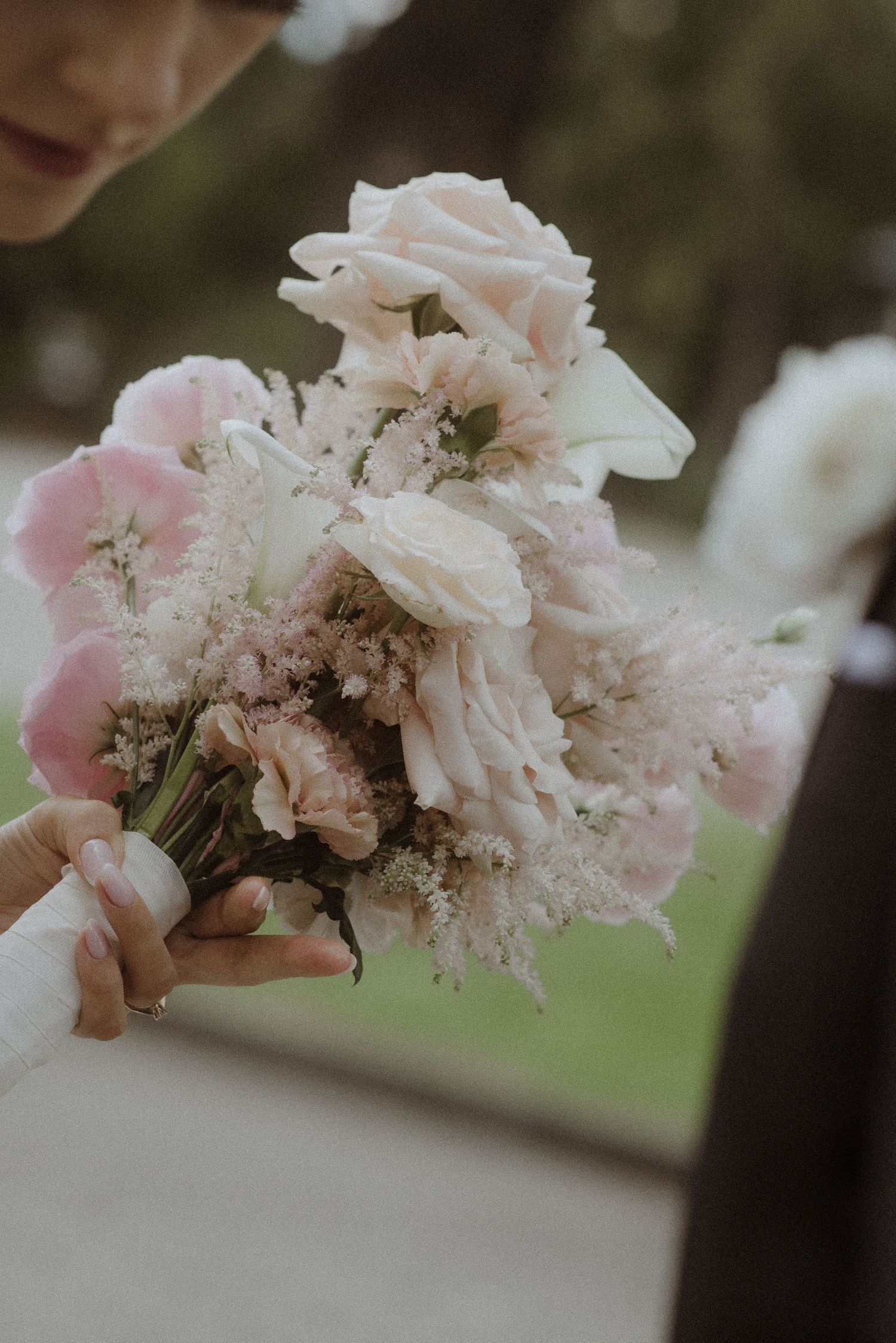 Delicate pink and white floral arrangement with soft romantic lighting.