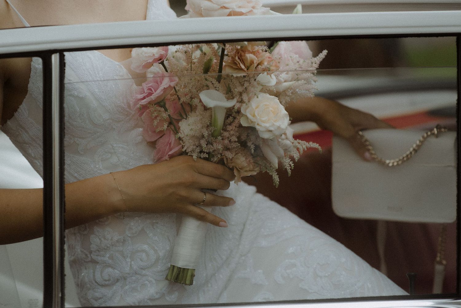 A row of wedding dress details showing delicate lace patterns and floral bouquets in soft lighting.