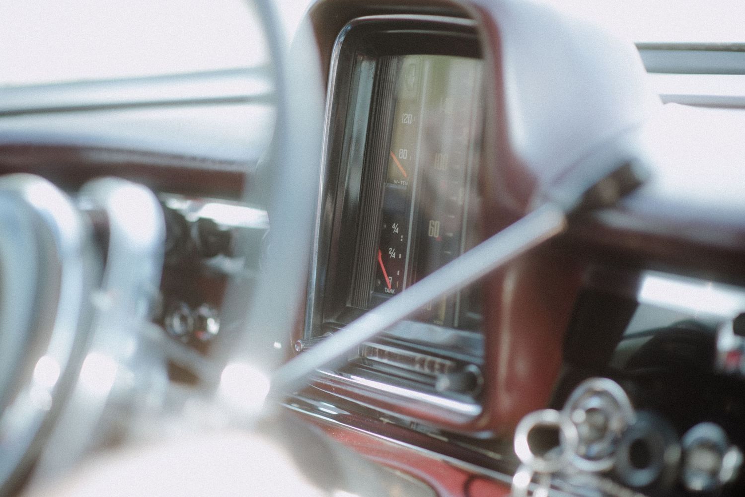 Abstract close-up of car dashboard instruments in monochrome.