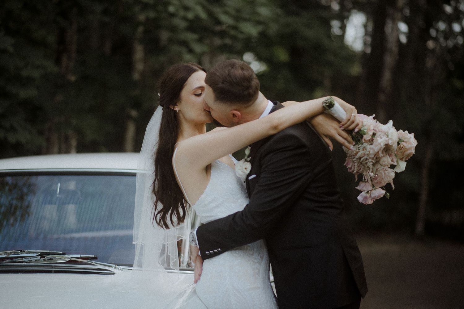 Romantic wedding photography sequence with couple posing near trees at dusk.