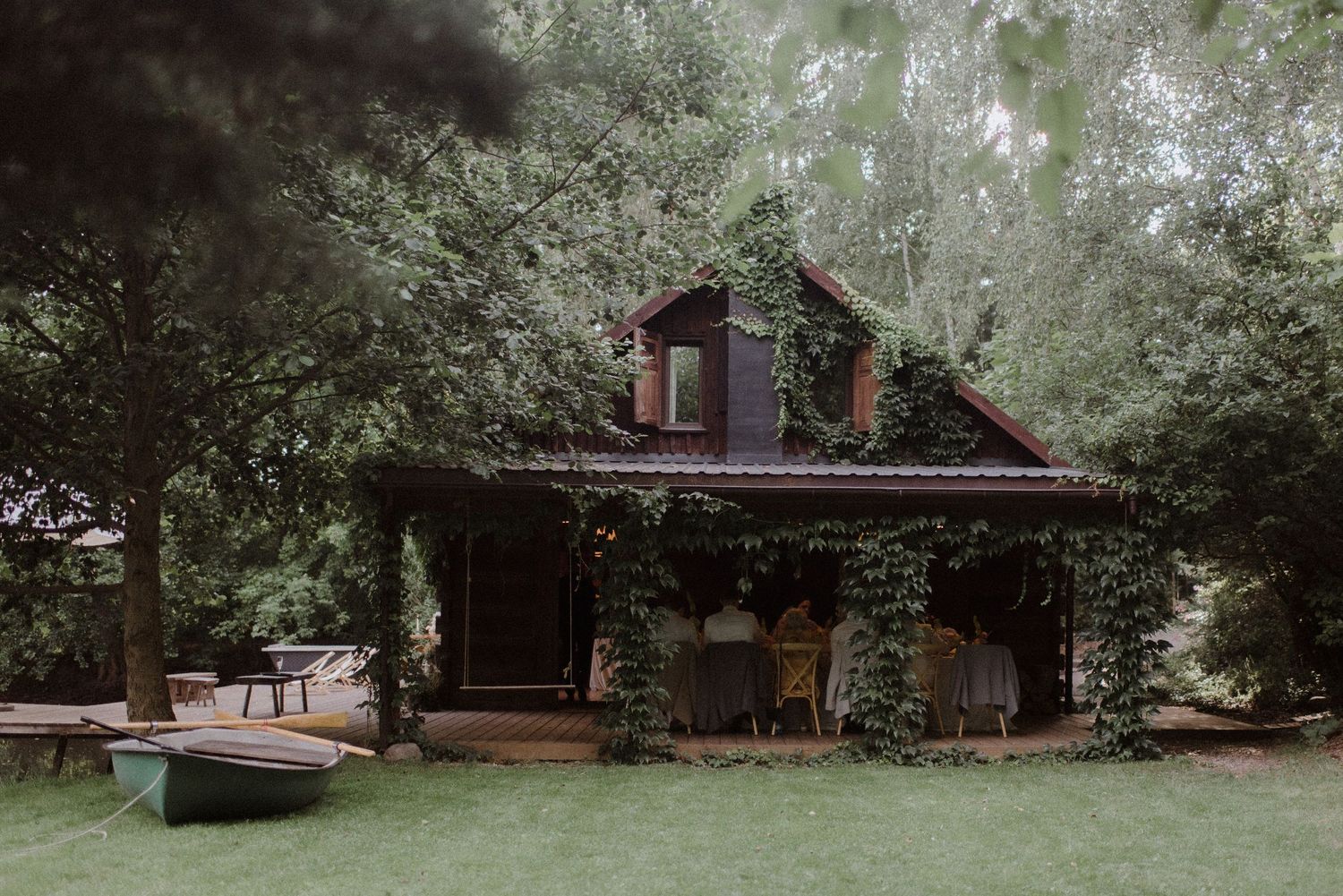 Natural wooded wedding venue setting with lush greenery and elegant landscaping.