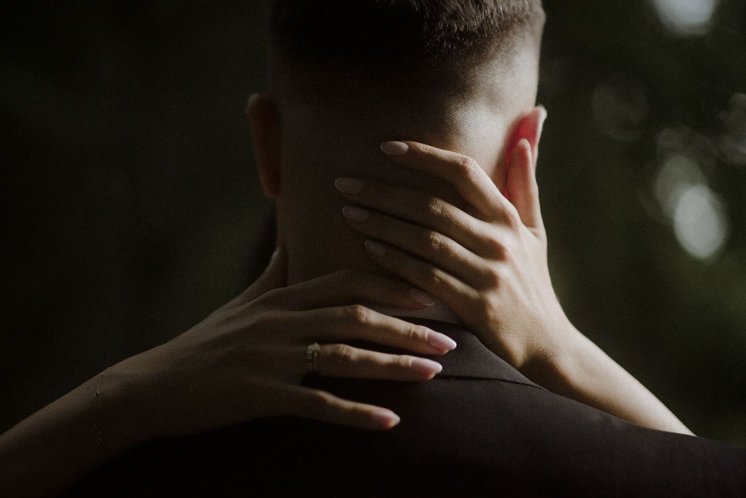 Close-up silhouette shot focusing on the back of a neck with dramatic lighting.