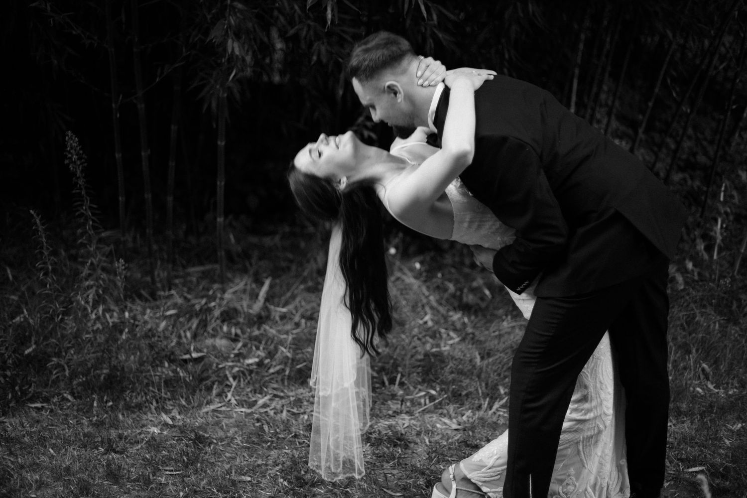 Black and white images capturing intimate moments from a wedding celebration outdoors.