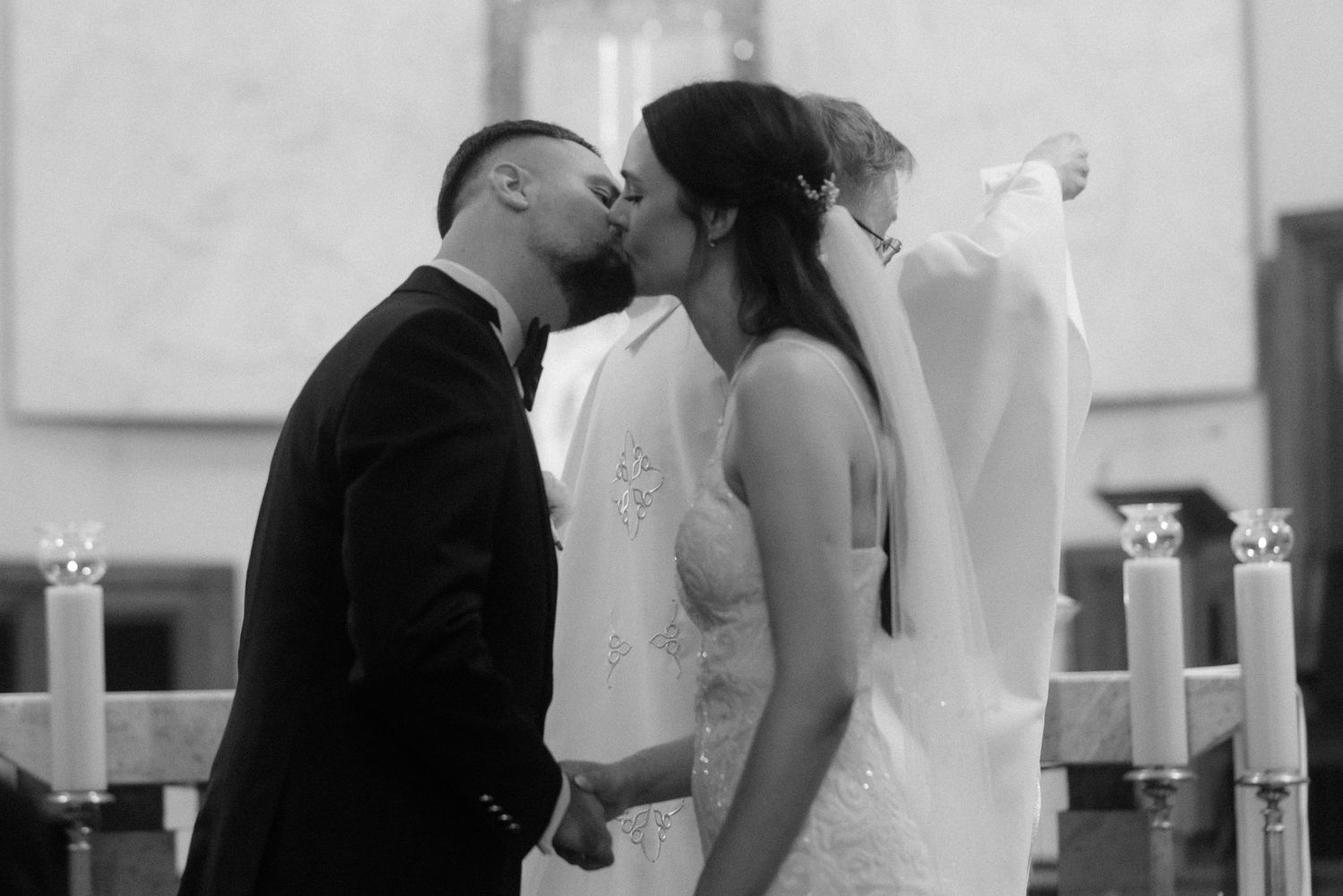 A black and white wedding montage showing couples dancing and embracing at a reception celebration.
