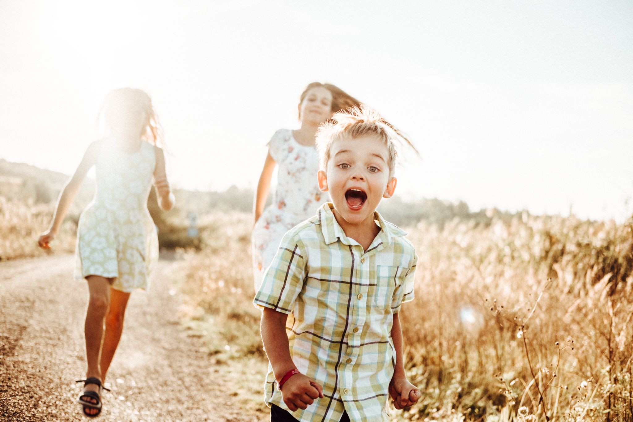 Kids enjoying playful moments in golden summer light.