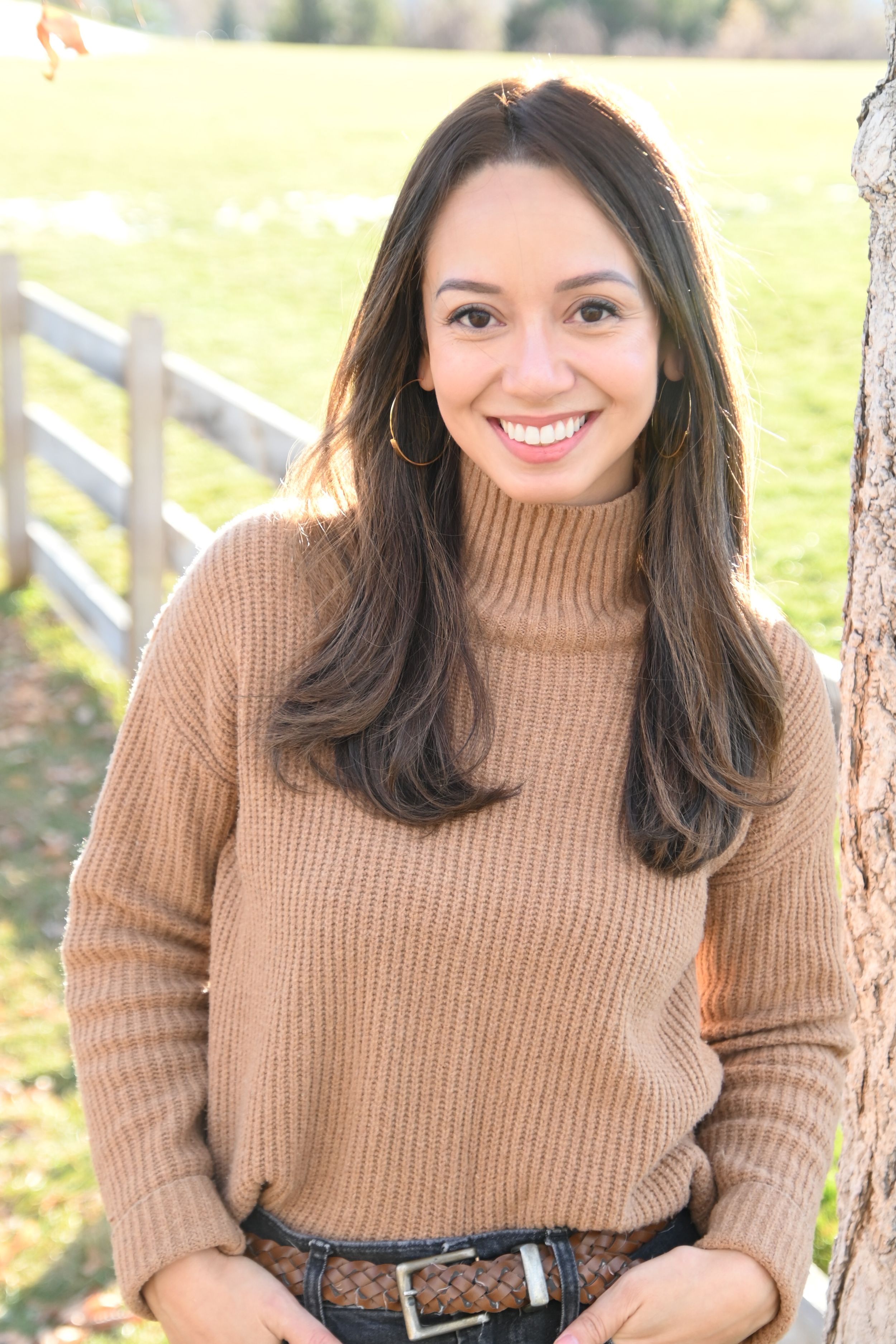 A series of portraits show someone wearing a cozy brown turtleneck sweater against an outdoor backdrop with wooden fencing.