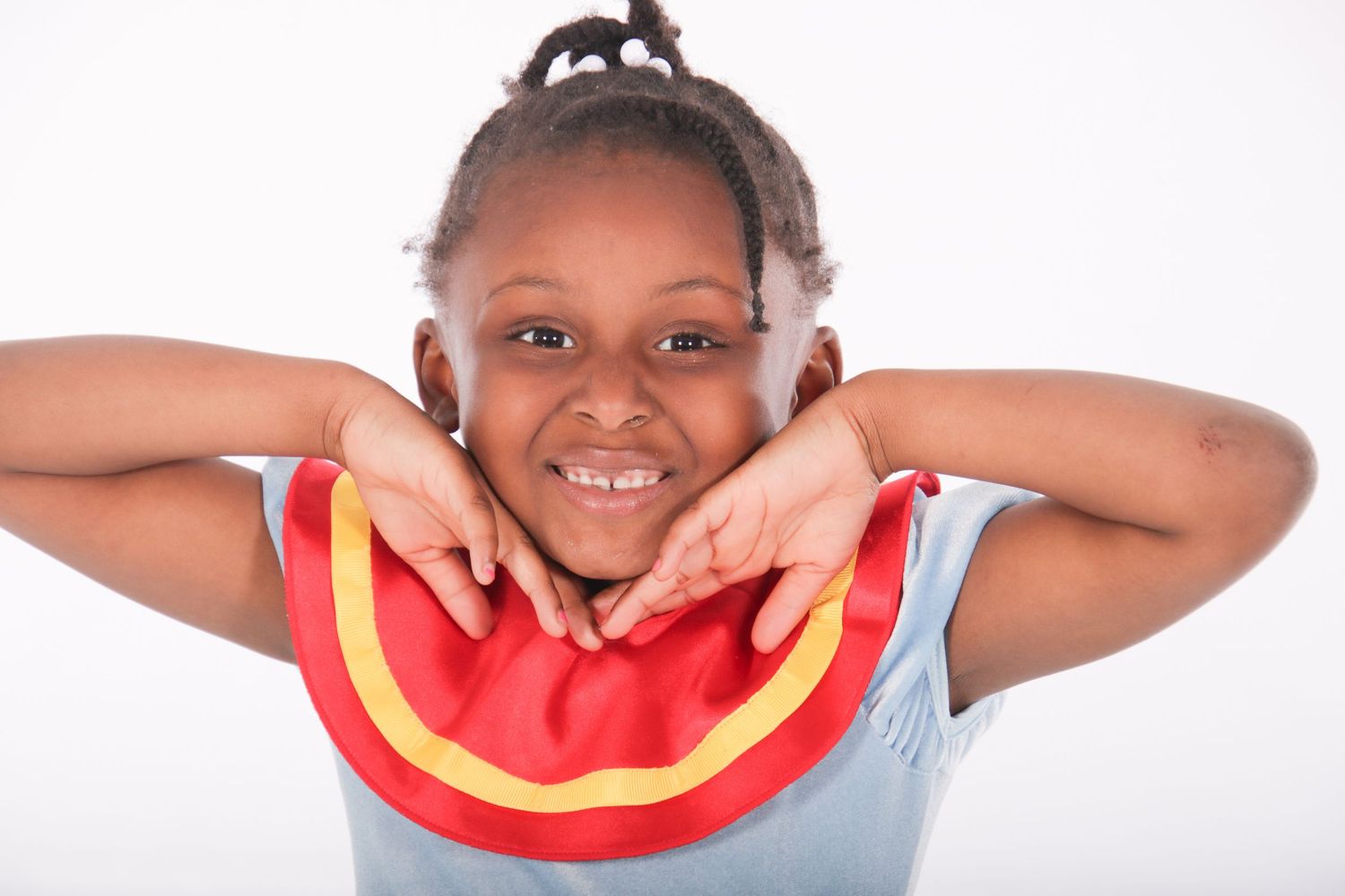 Joyful poses with a red circular prop against white background.