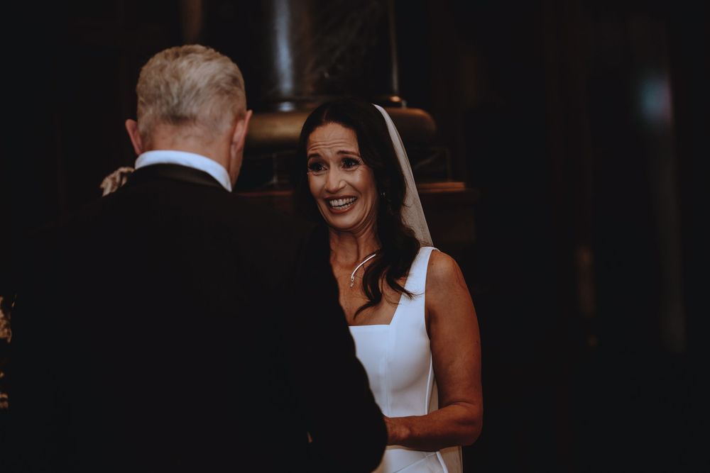 A happy couple dancing together during their wedding reception at an indoor venue.