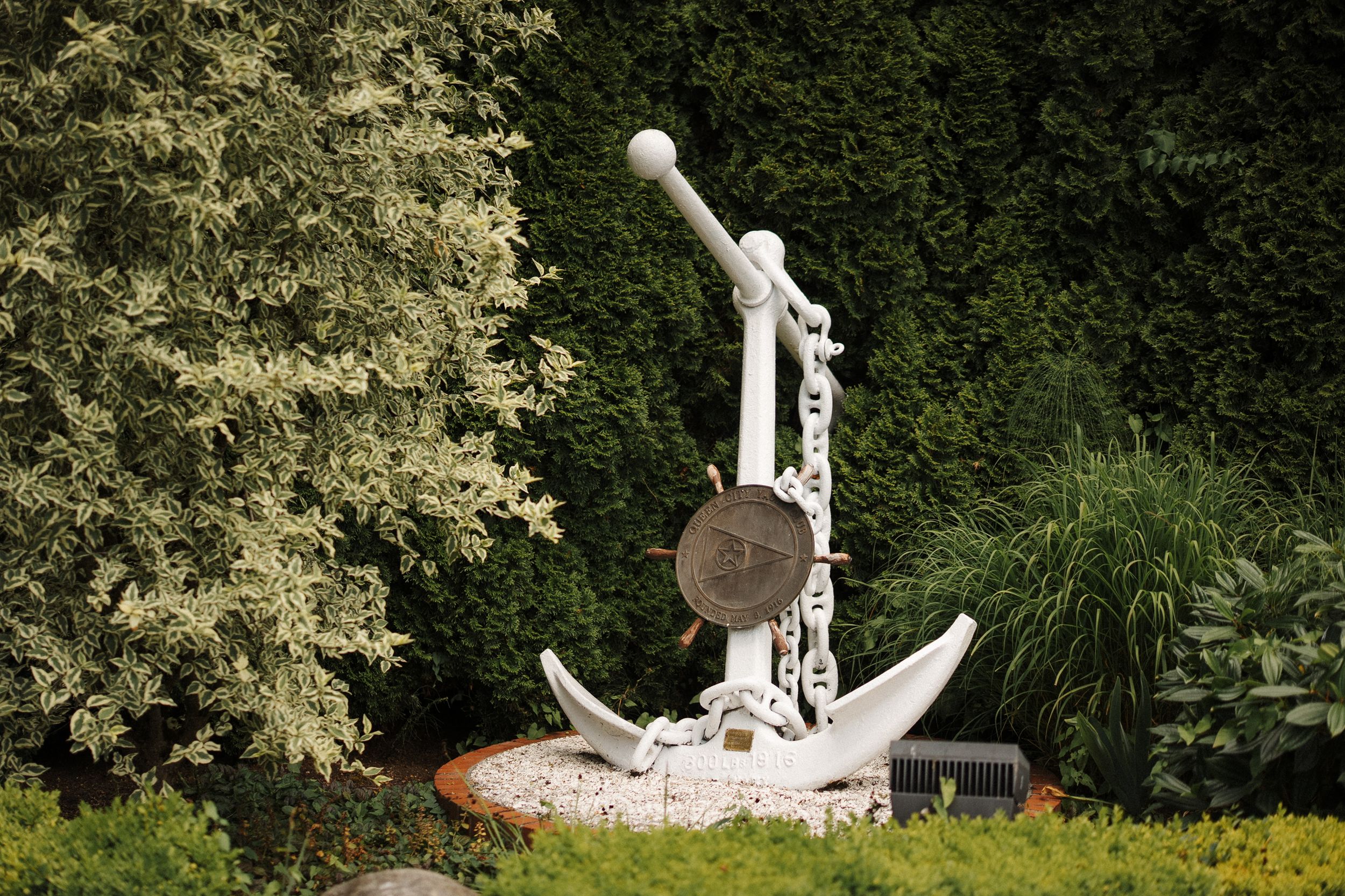 Scenic garden fountain and decorative sculpture installation with water features surrounded by lush greenery.