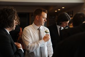 A group of formally dressed people having drinks and mingling at an evening social event.