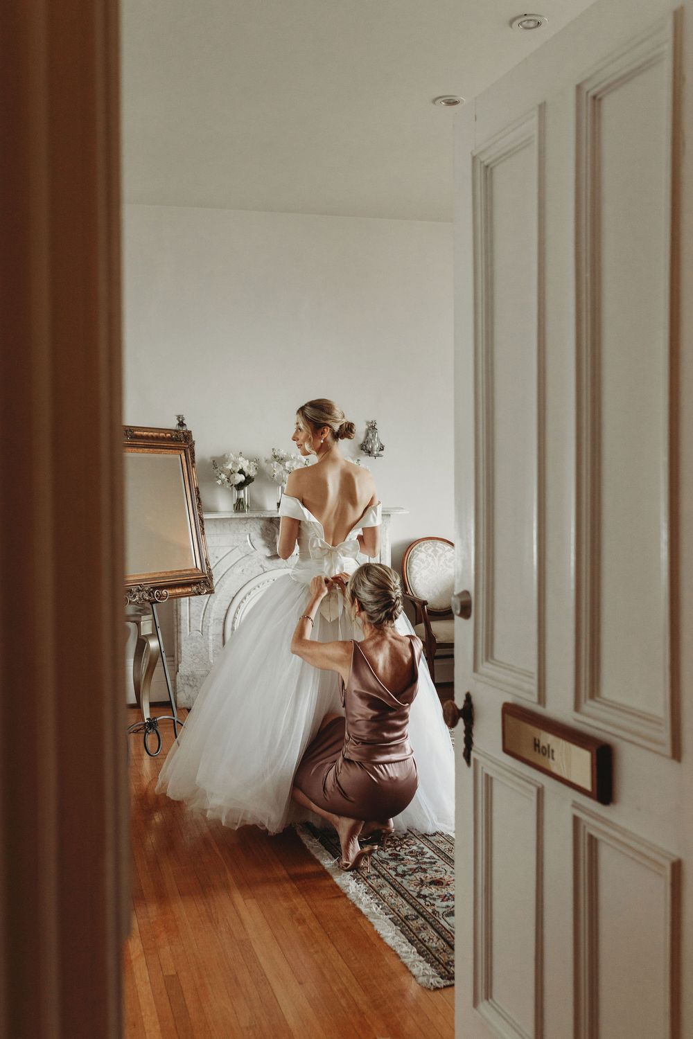 A wedding dress spins in motion against white walls and hardwood floors creating an elegant flowing motion effect.