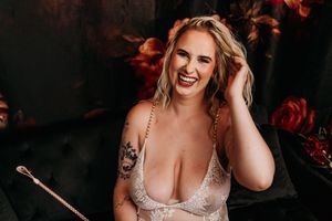 Intimate portrait with delicate lace bodysuit in romantic dark setting with red florals. Nice & Naughty Store Event Grand Rapids MI Boudoir