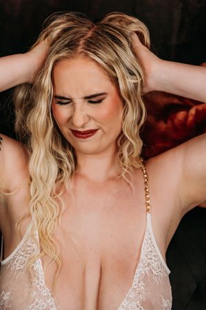 Dreamy boudoir photography with soft lighting and romantic white lace details. Nice & Naughty Store Event Grand Rapids MI Boudoir Marathon