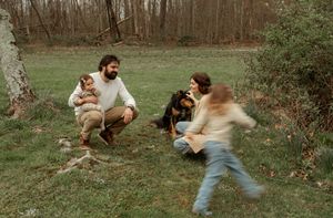 Series of action shots showing playful rough-housing between a dog and its owner in an outdoor field setting.