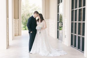 Wedding portraits captured in a beautiful architectural colonnade with natural light.
