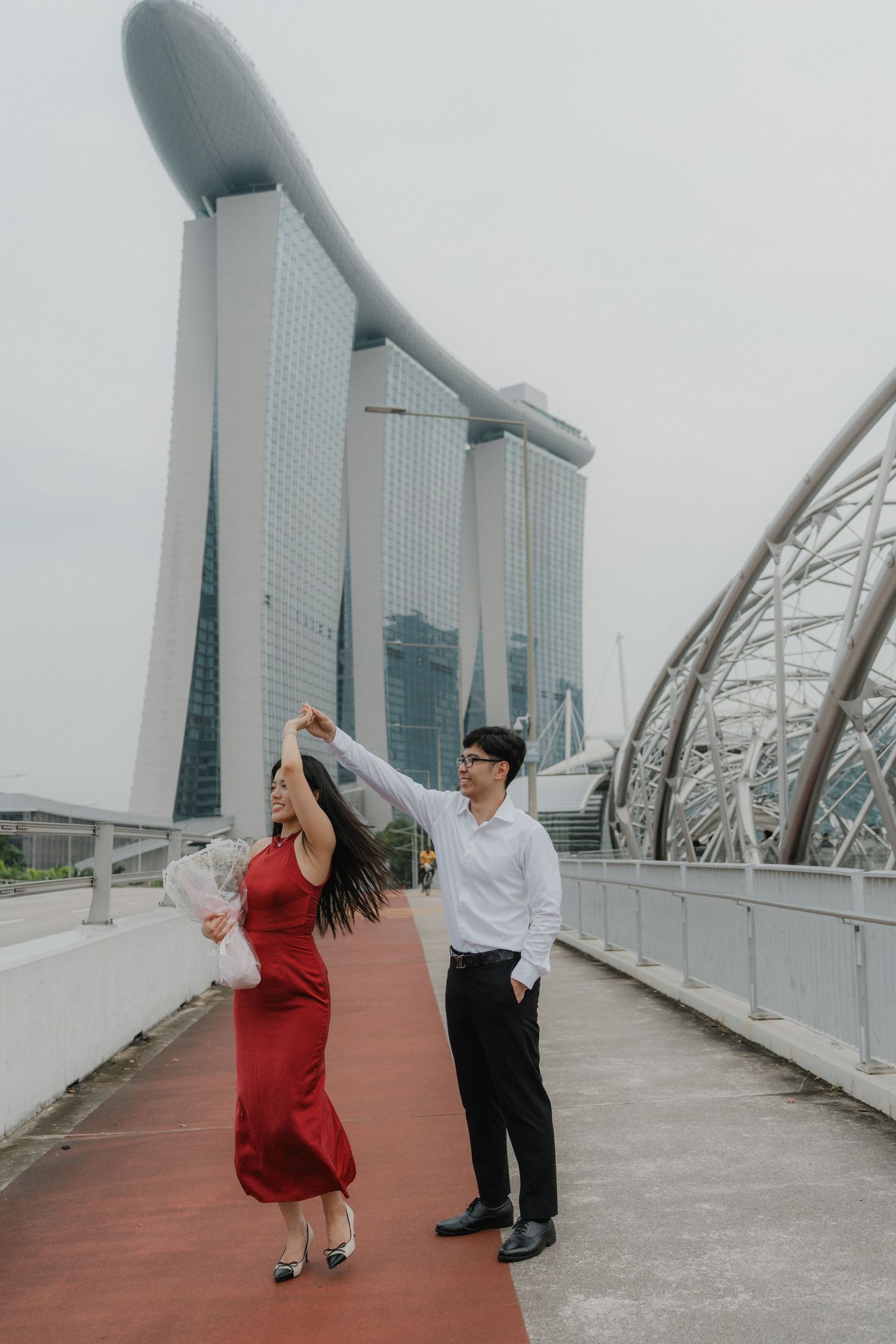 A romantic dance sequence on a bridge overlooking Singapore's iconic Marina Bay Sands towers.