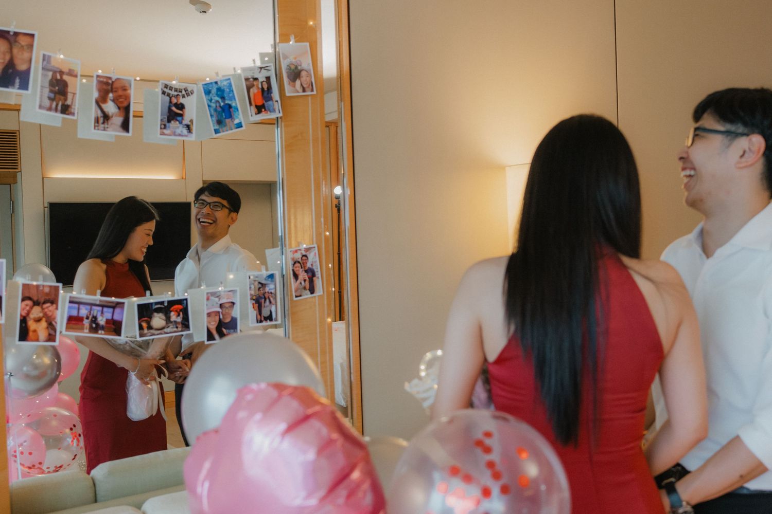 Festive engagement scene with photo memories displayed and pink balloon decorations.