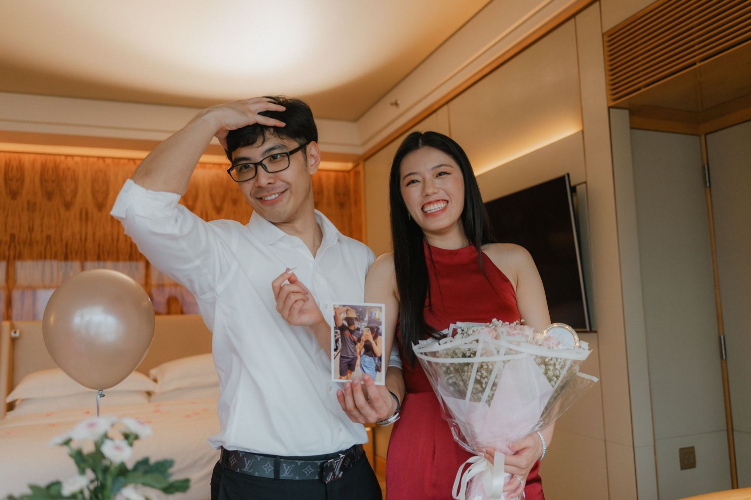 Romantic indoor celebration with balloons and decorative lighting creating an intimate atmosphere.