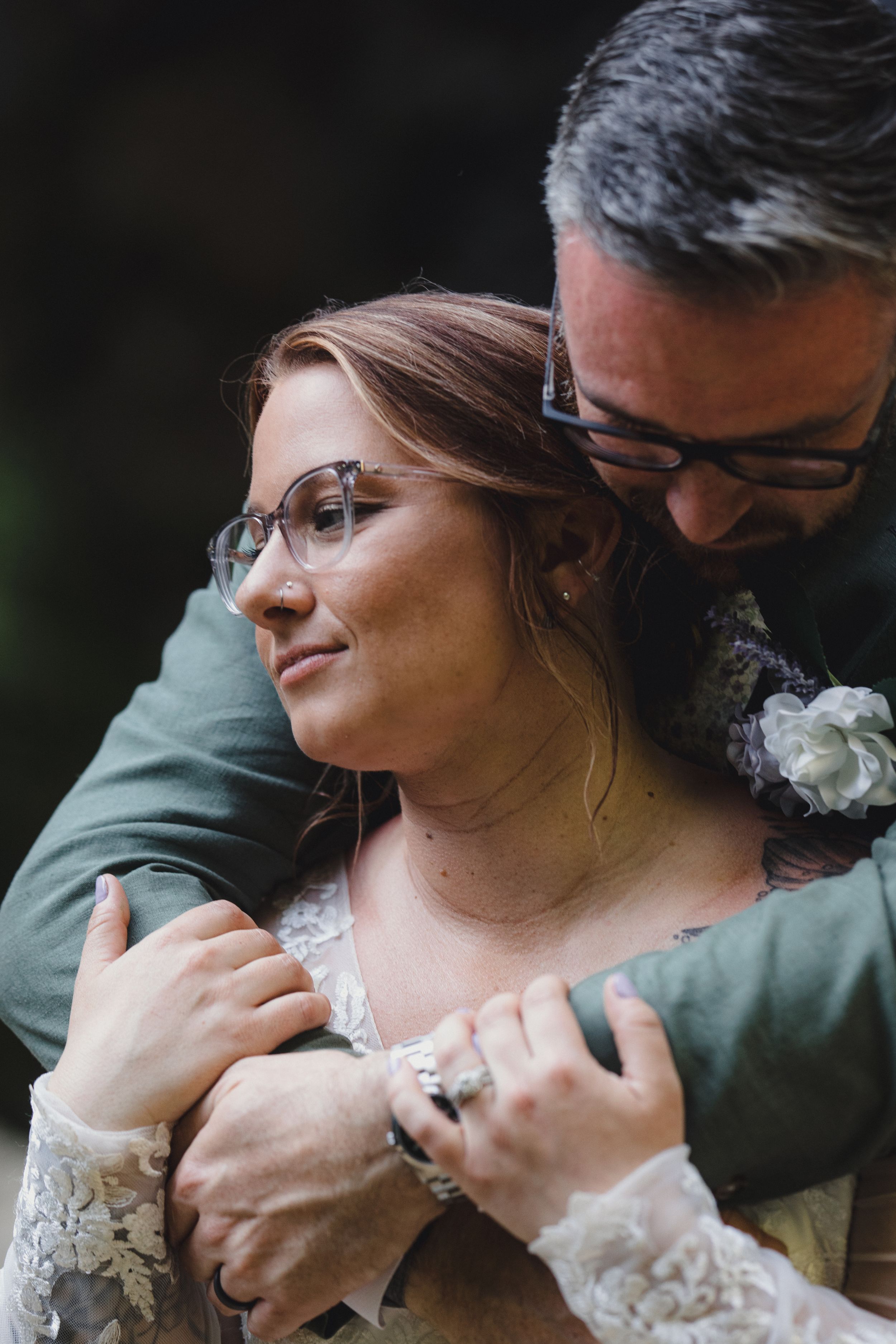 Tender embrace moments captured in intimate forest wedding photography session.