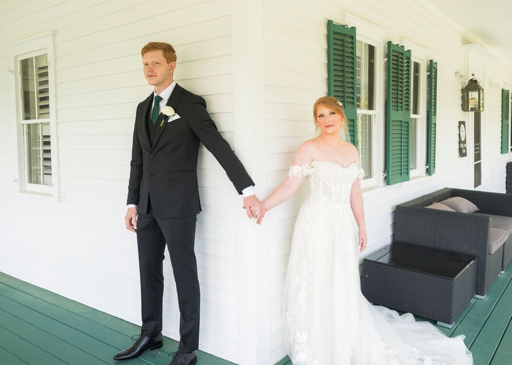 Wedding party candid moments captured in white and green exterior porch setting.