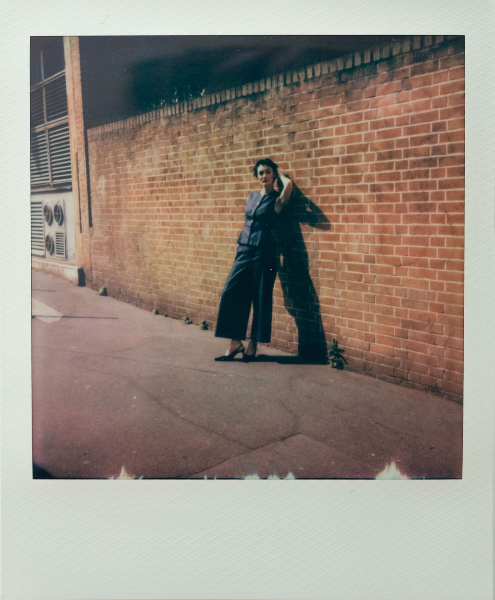 A series of vintage-style polaroid photographs showing dark silhouettes against a brick wall background.