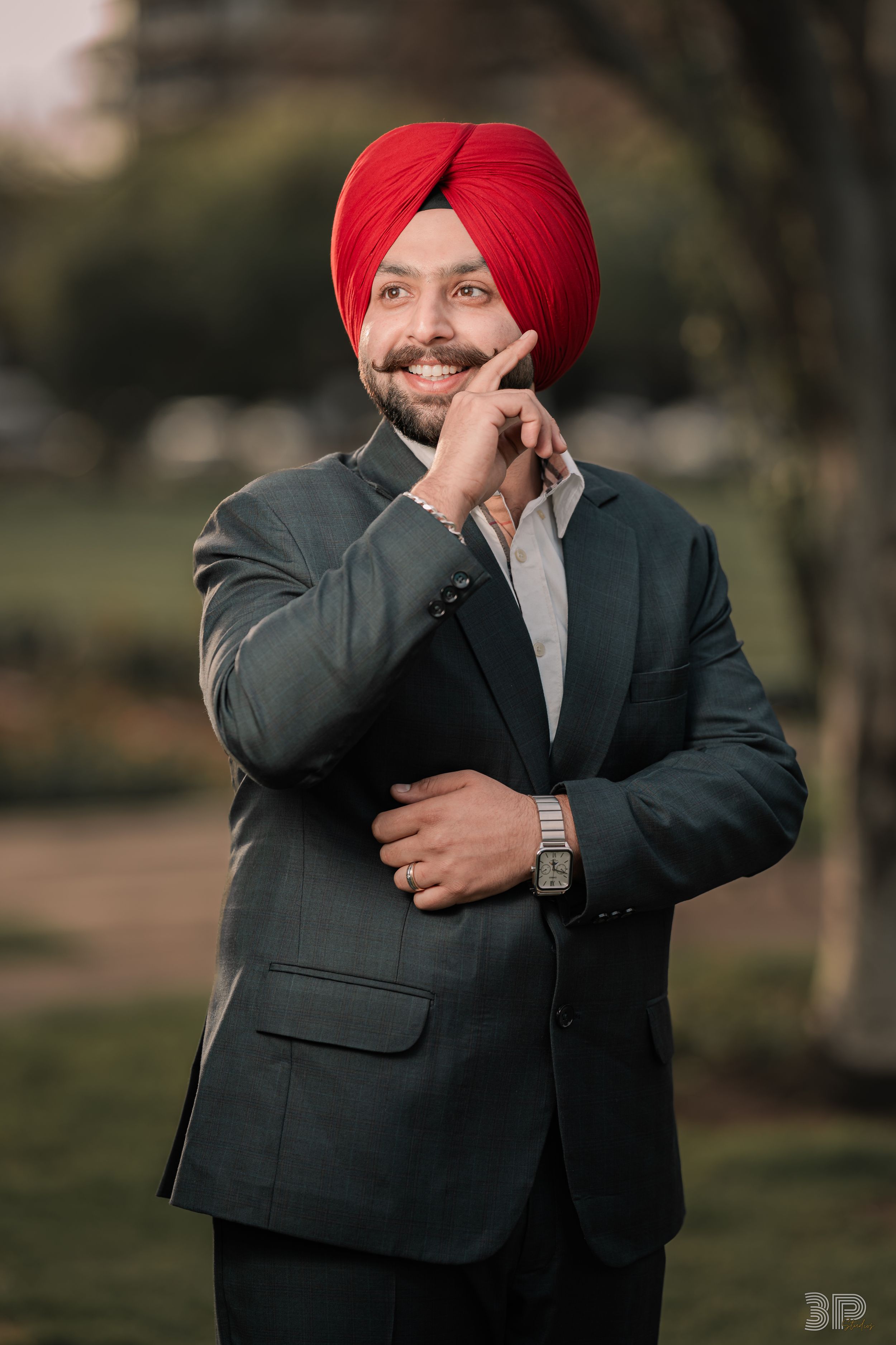 Progressive sequence showing person in suit and red turban expressing joyful emotions against natural backdrop.