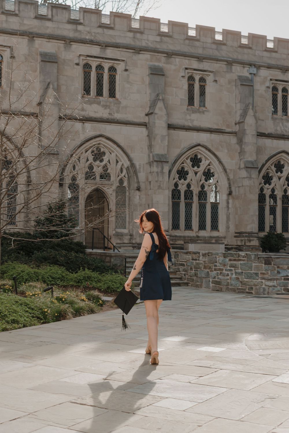A dance performance sequence captured in front of a stone gothic building with arched windows.