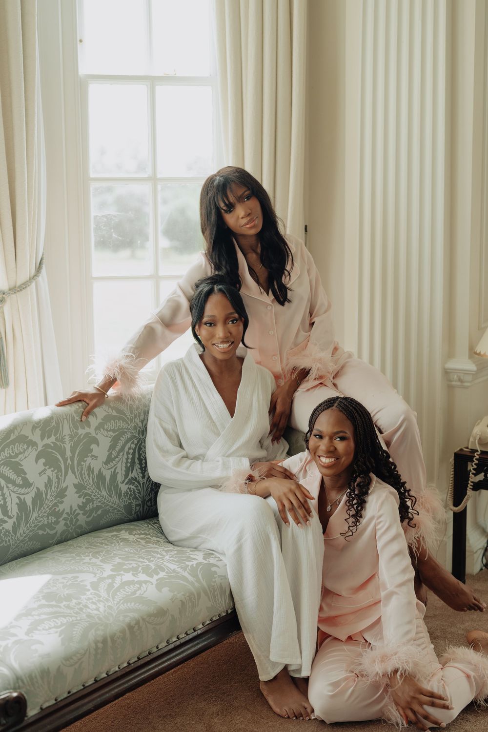 Wedding party members relaxing in robes during pre-ceremony preparations.