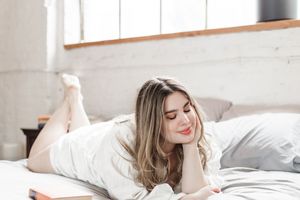 Bright lifestyle photography series showing relaxed poses on white bedding in natural light.