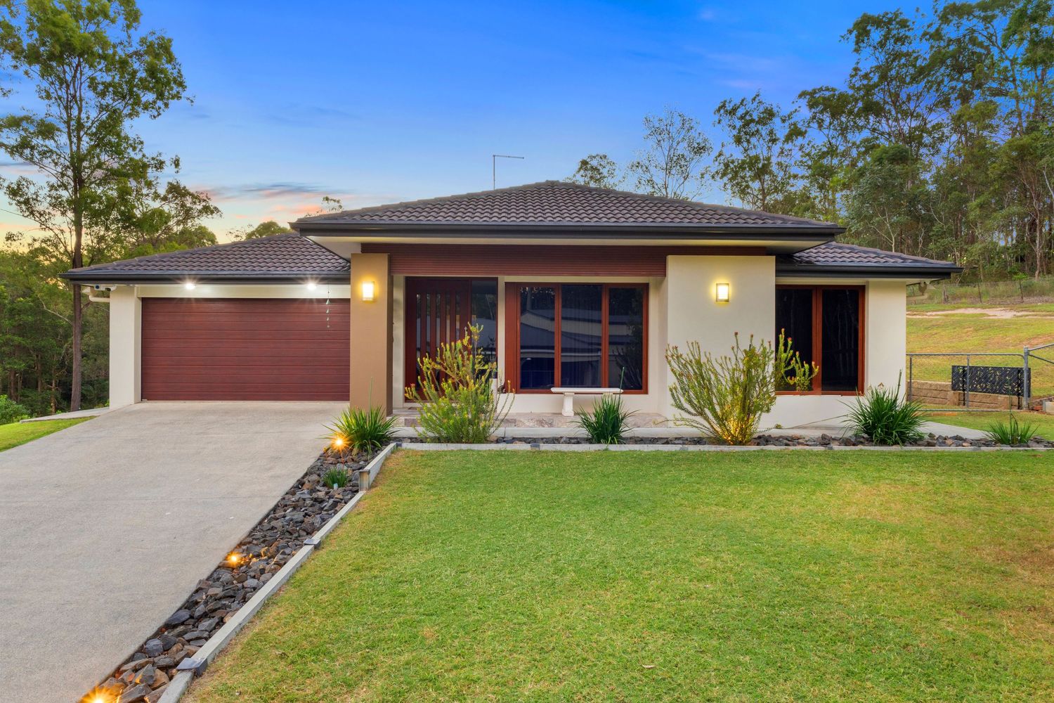 Contemporary duplex house exterior with modern architectural design and landscaped frontage.