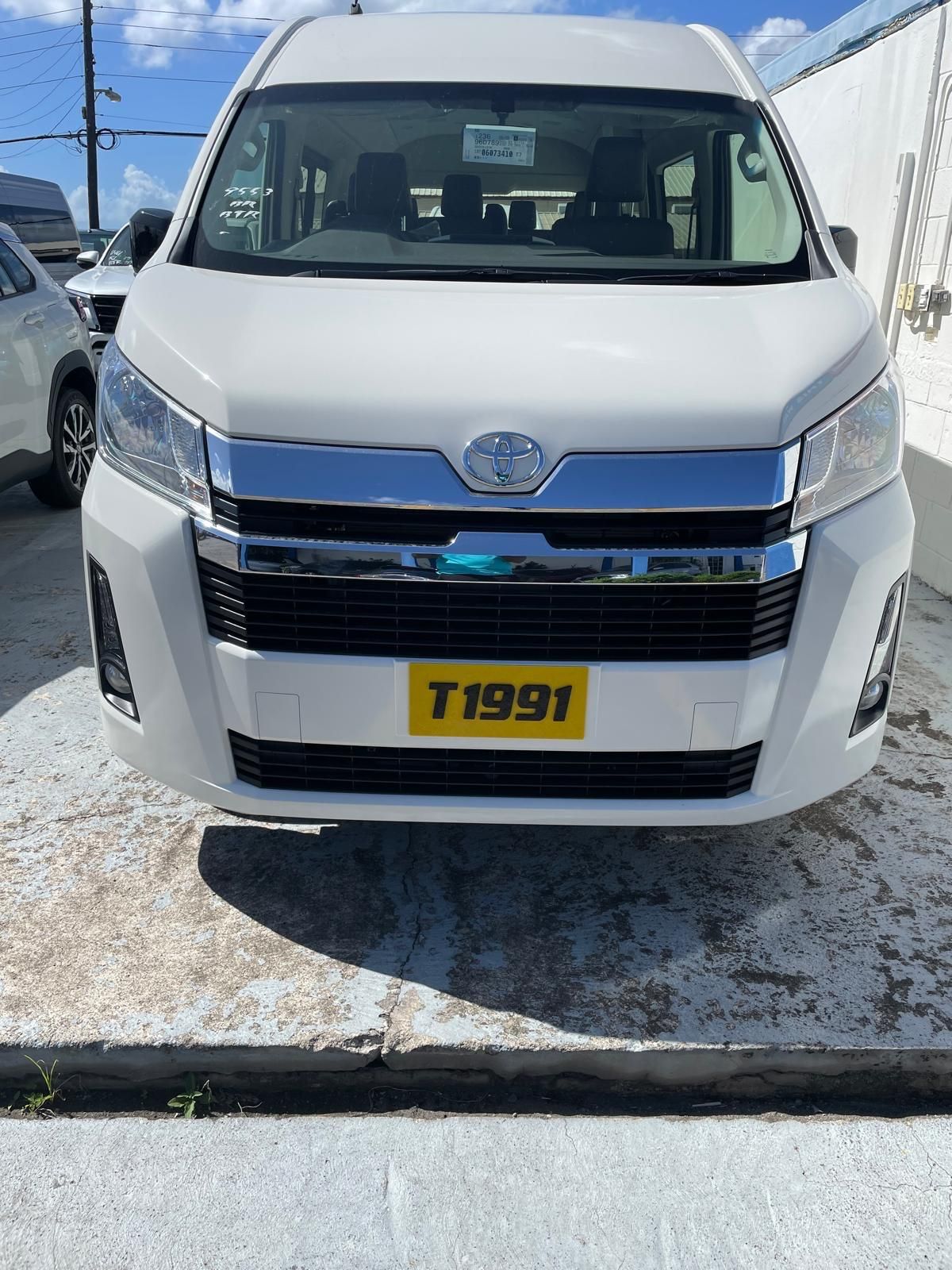 White Toyota HiAce vans and others