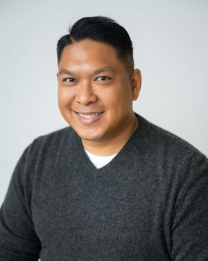 Professional headshot of someone wearing a dark gray sweater against a light gray background, showing different expressions.