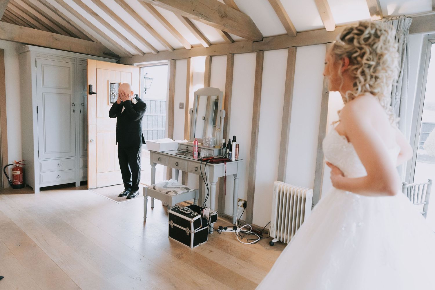 A wedding day sequence showing a hallway with white beams and elegant decor in a rustic venue setting.