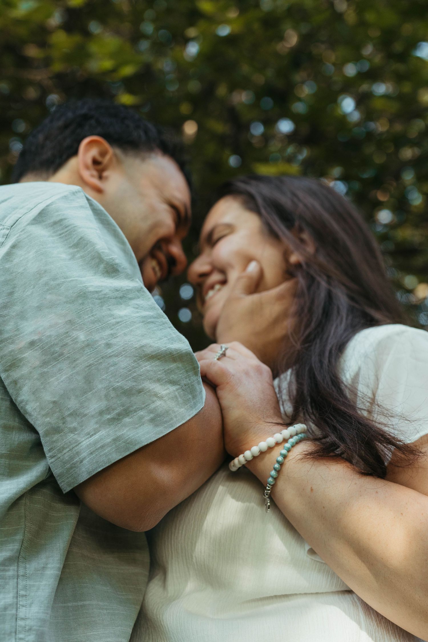 Romantic close-up shot of a couple sharing an intimate moment outdoors.