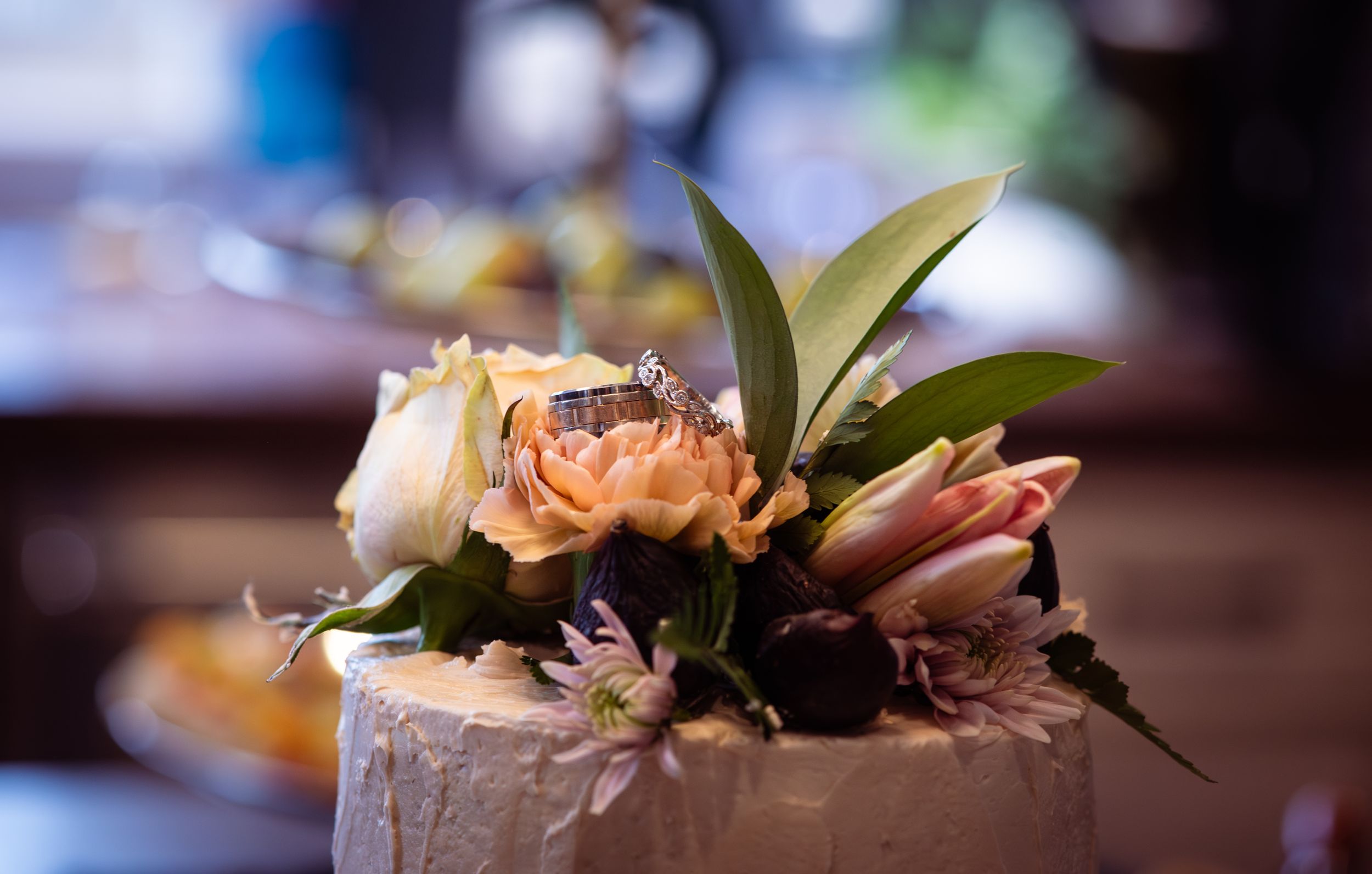 A close-up view of pink and orange floral arrangements with blurred background creating a romantic ambiance.