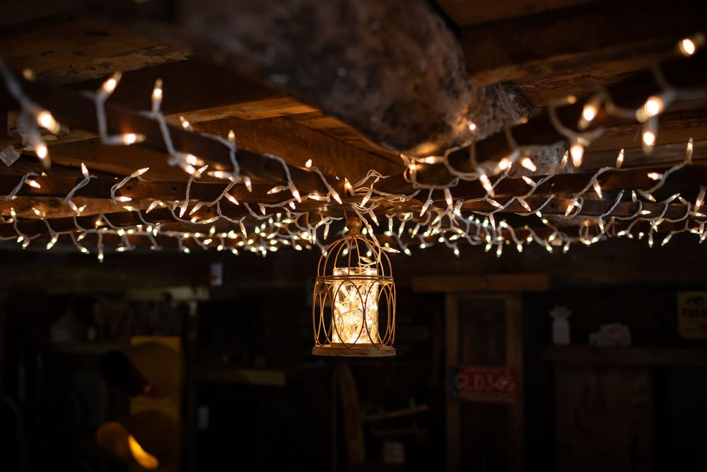 Wedding reception venue decorated with twinkling string lights creating a romantic ambiance overhead.