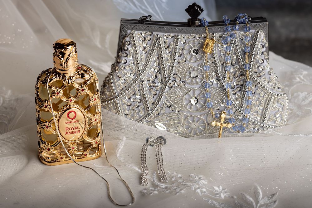 Elegant crystal tiaras and golden jewelry pieces displayed on a light surface with sparkling details.