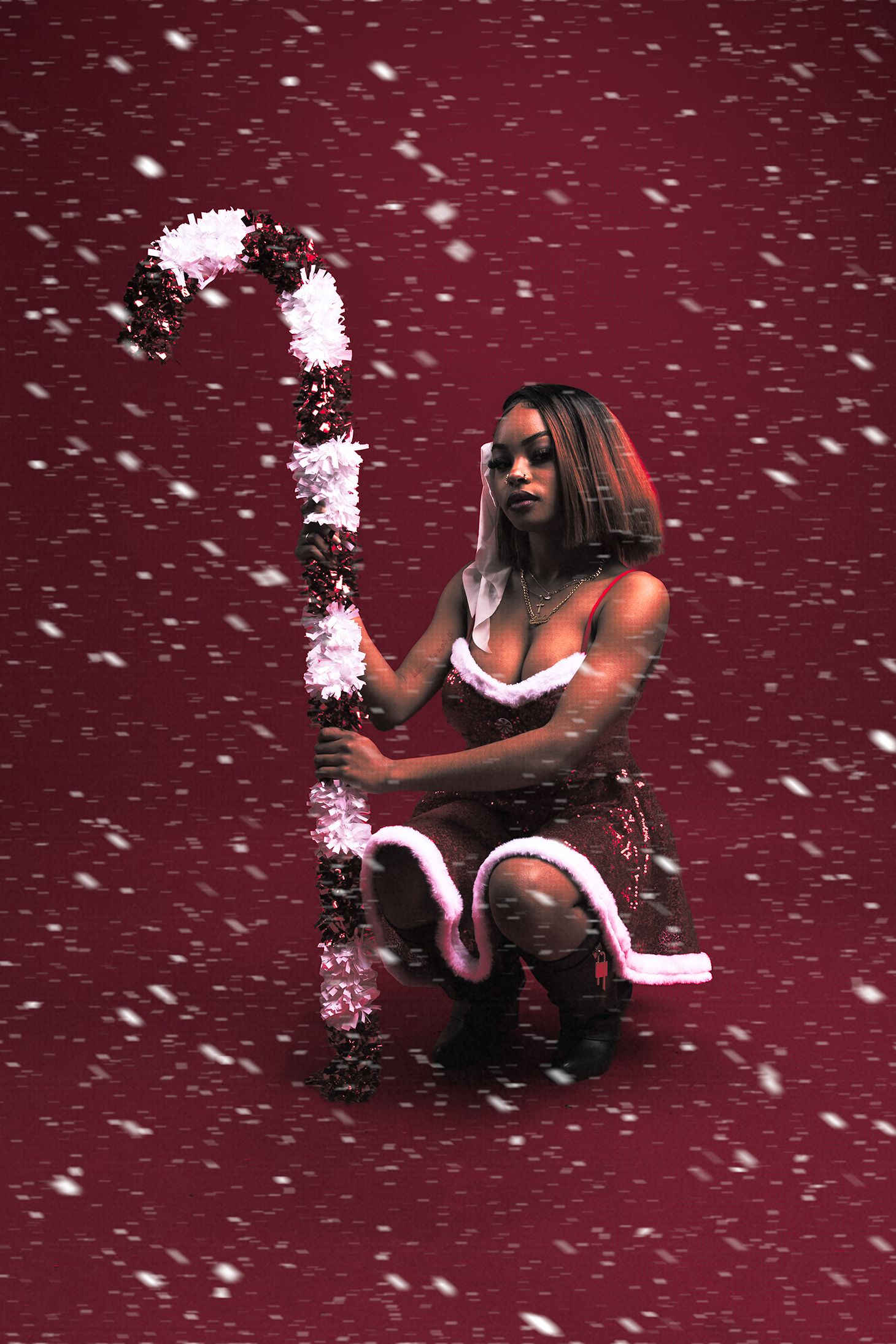 Dramatic winter scene with figure in action pose against snowy burgundy background.