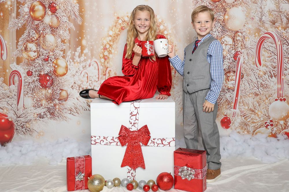 Christmas photo session setup with red and white decorations and ornaments.