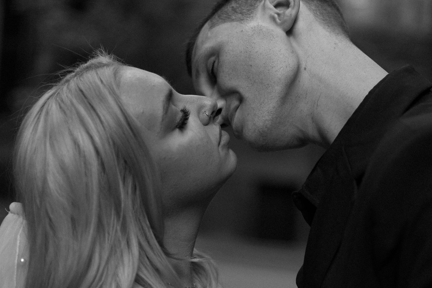 A black and white collage of romantic couples kissing in various intimate poses.