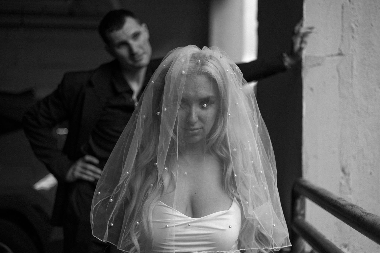 A dramatic black and white wedding photo sequence showing intimate moments between a couple.
