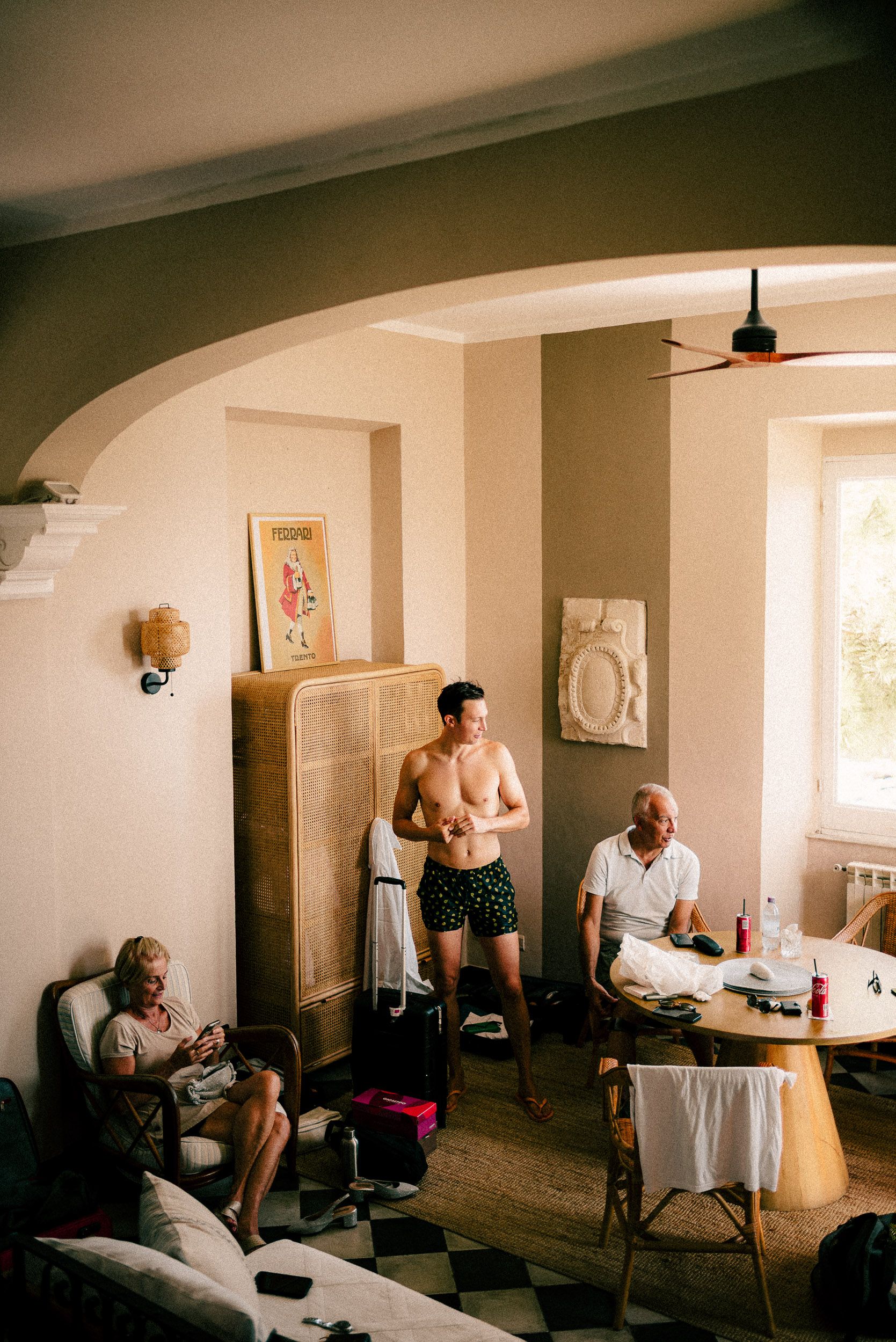 A series of intimate indoor scenes showing people in a dimly lit room with natural light streaming through windows.