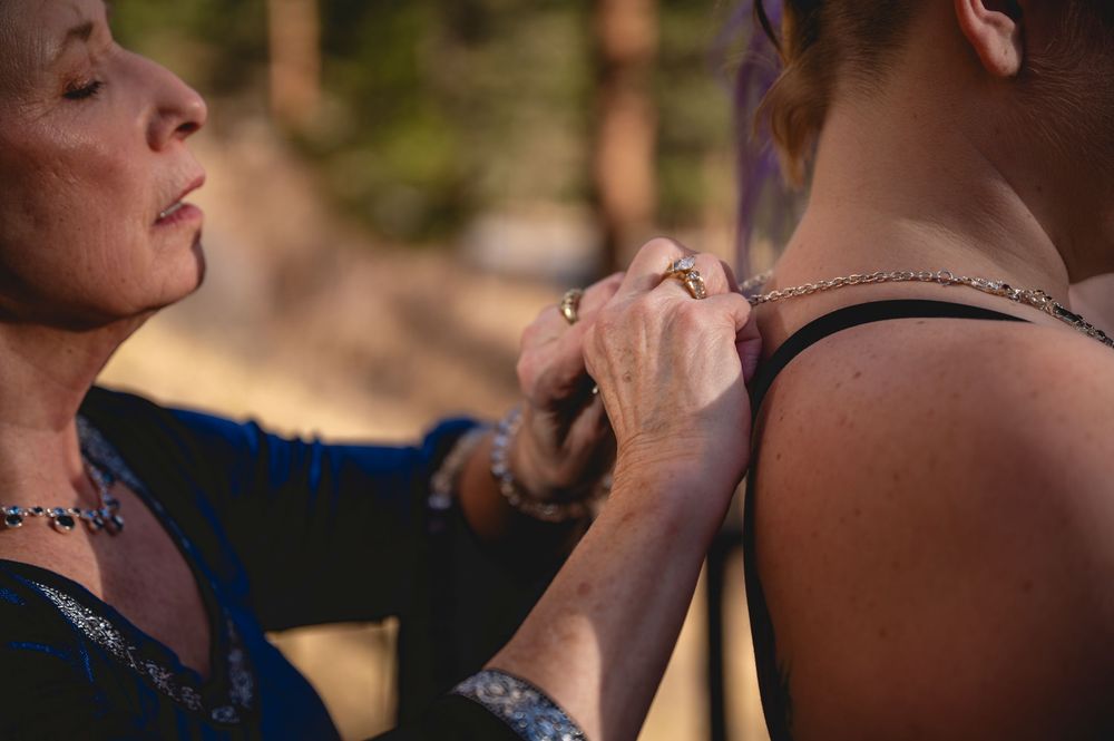 A close-up shot of someone receiving a therapeutic massage on their shoulder and neck area outdoors.