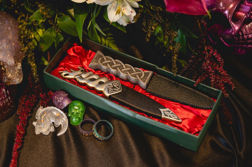 Festive holiday decorations with red berries, white flowers, and evergreen branches arranged on a wooden surface.