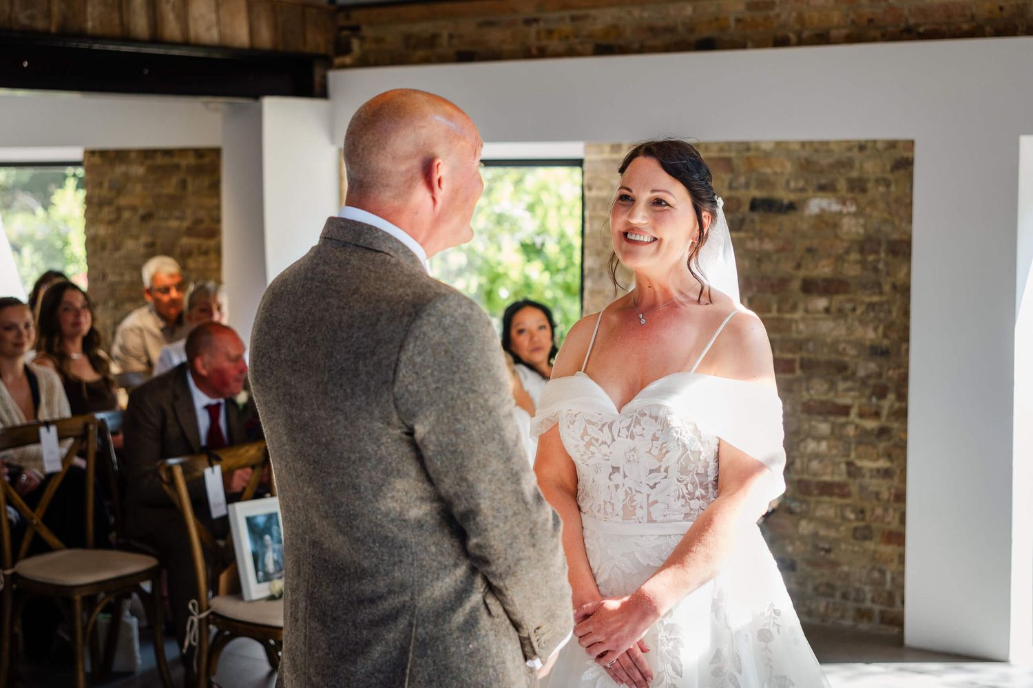 bride and groom smiling at each other