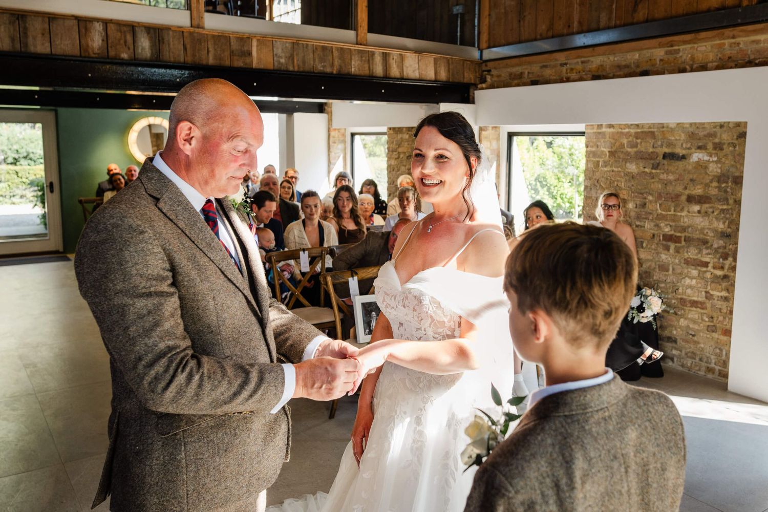 bride and groom laugh at wedding in chapel house